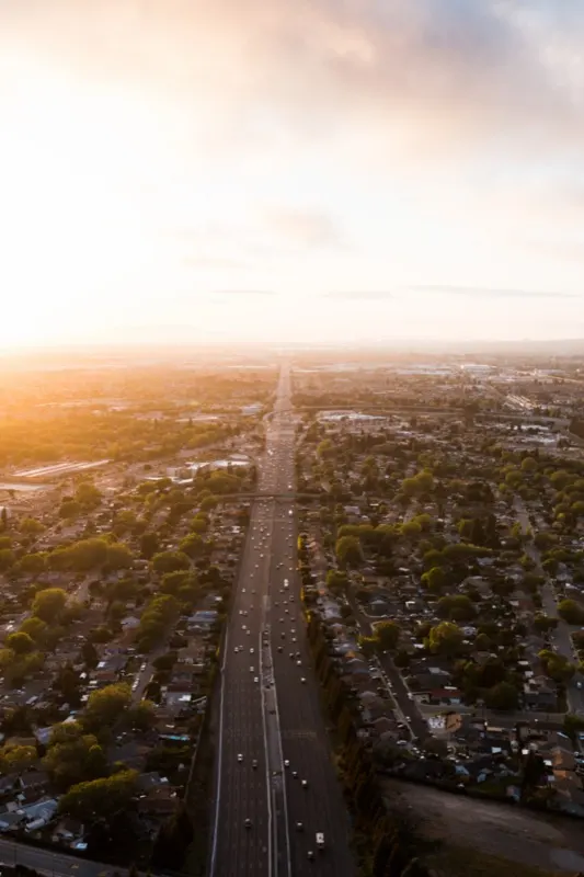 Highway running through a residential area at sunrise